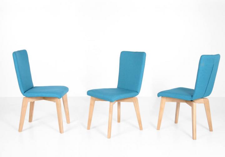 Manon von Standard Furniture Speisen Stuhlsystem mit verschiedenen Sitzschalen und markantem Holzgestell